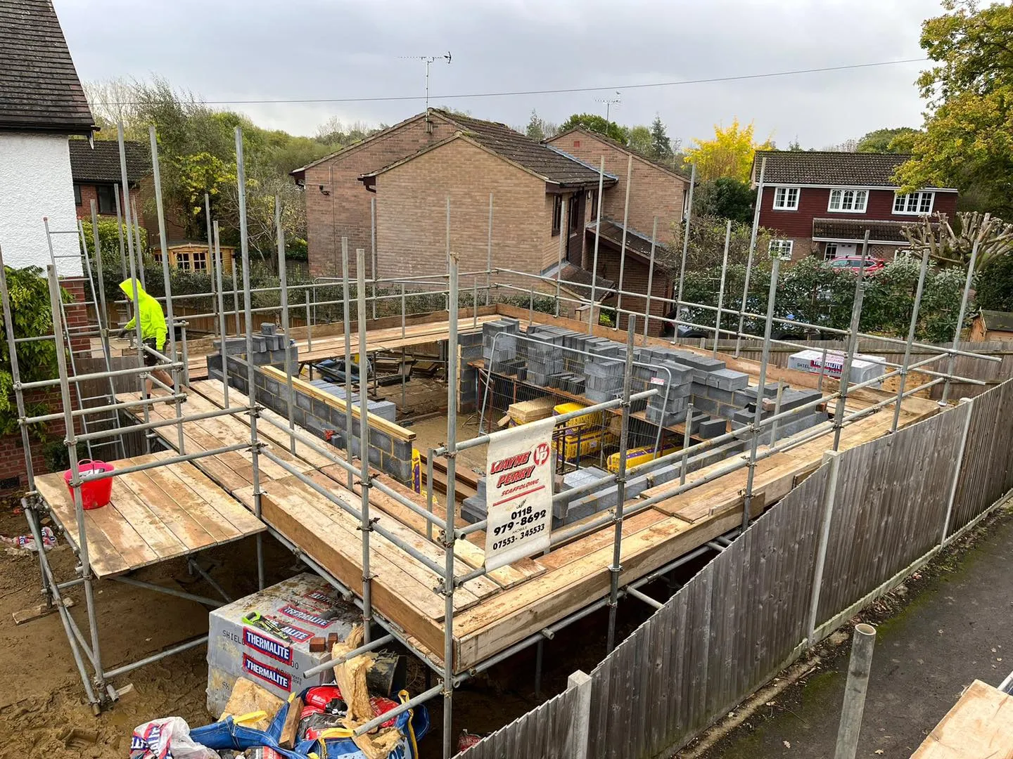 A house under construction with scaffolding around it.