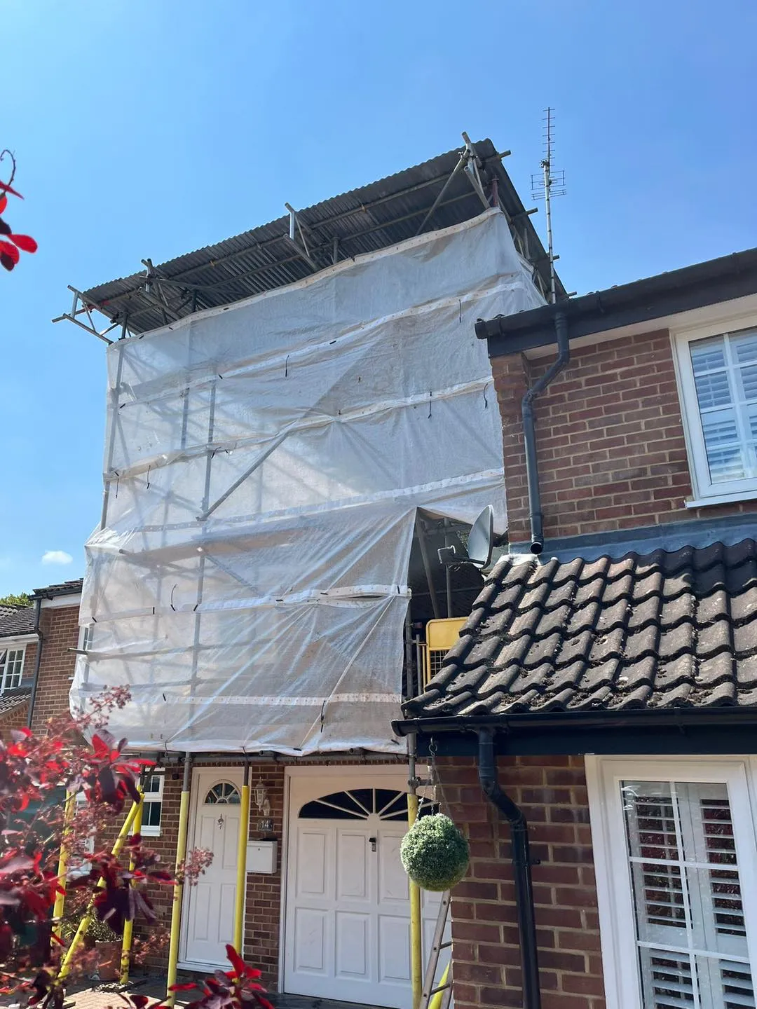 A house with a tarp covering the front of it.