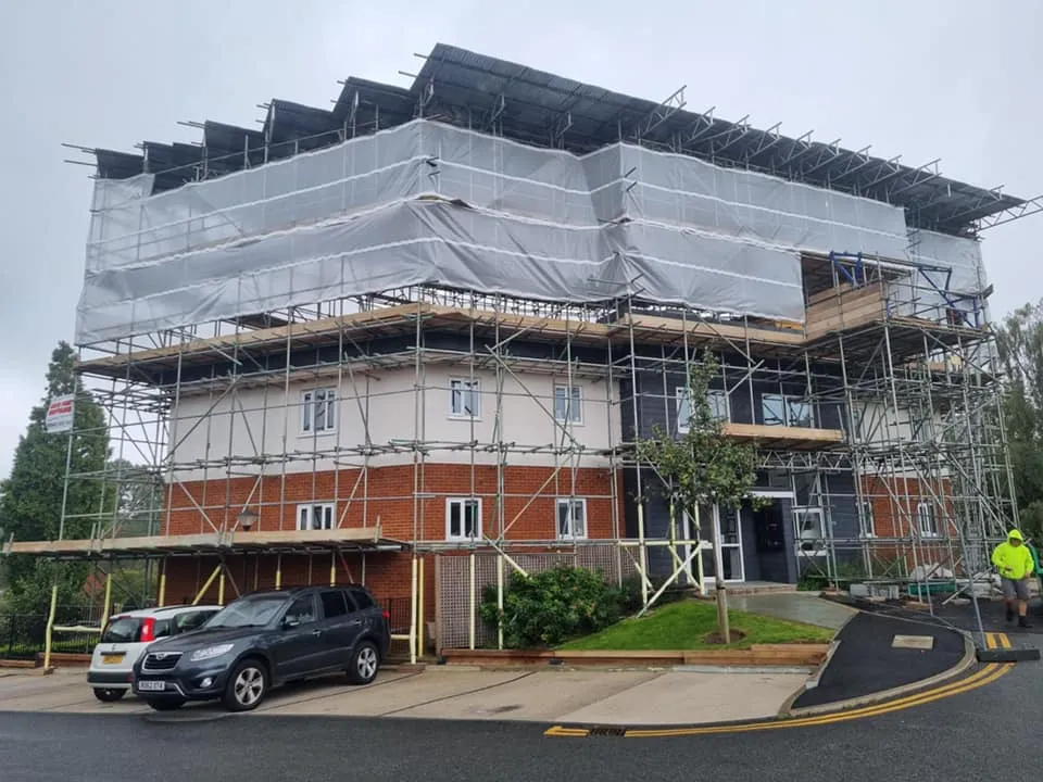 A building under construction with scaffolding on top of it.