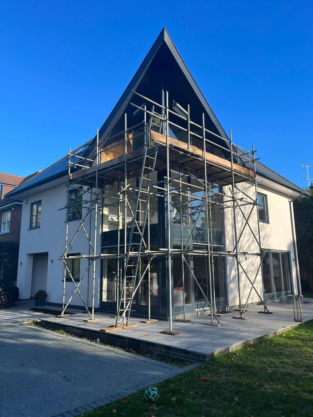 A house being built with scaffolding on the front of it.